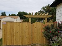 <b>6 foot high Pressure Treated Vertical Board Privacy Fence with an arched walk gate-Trellis over the gate</b>
